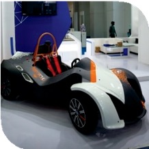 Concept render of a REEV vehicle shell displayed at an exhibition, in black and orange