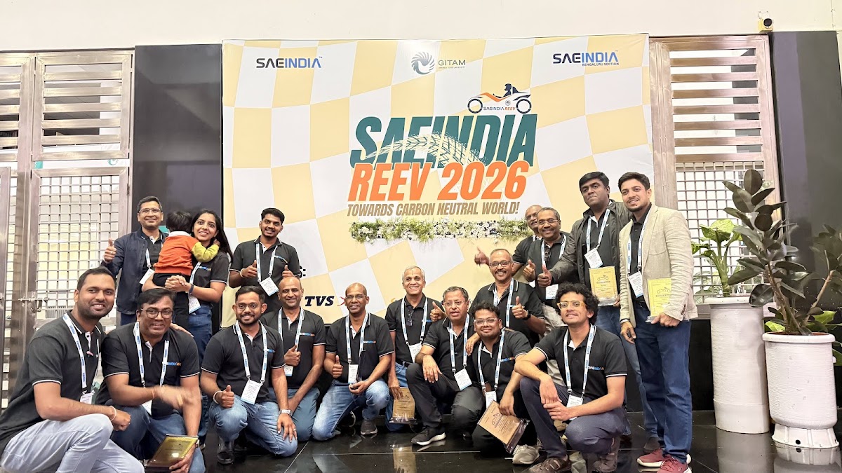Organizing team celebrating together on stage in front of the REEV SAEINDIA 2026 backdrop